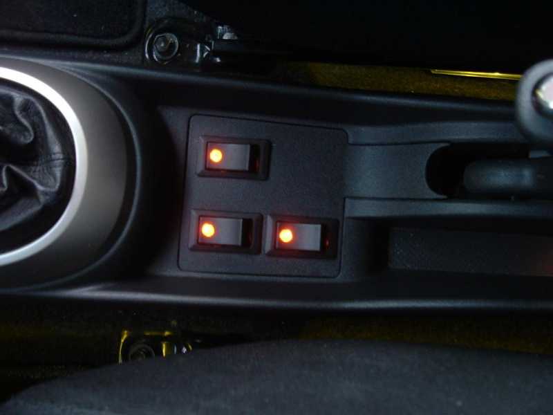 3 LED rocker switches installed in my Scion xB near the e-brake