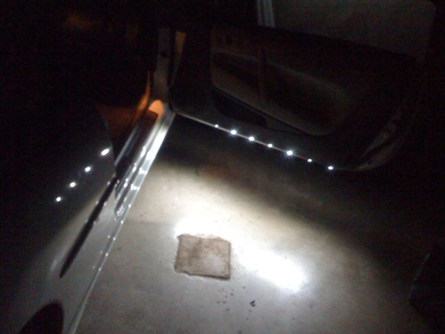 White courtesy lights, 8 LEDs per door spaced evenly and wired to a relay to turn off when the door is closed.