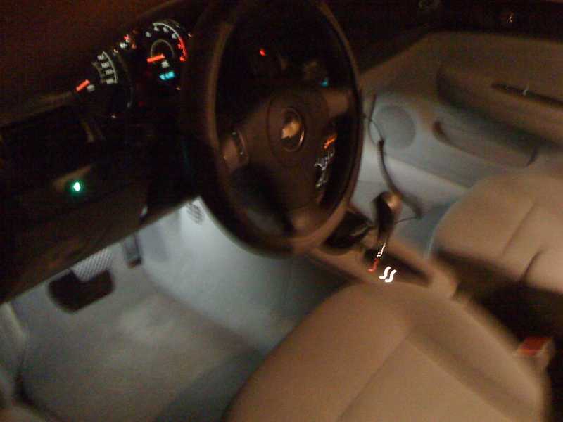 Pre-wired surface mount LED, cool white.  (1) in each foot well, interior light on.  Note green LED switch on left dash.