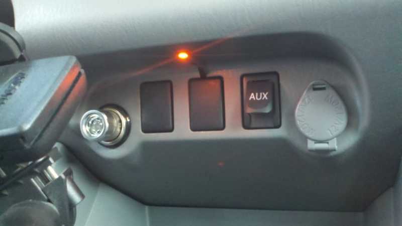 At night the cubbyhole in front of the cup holders is pitch black until now.  Wired to the dash light dimming circuit is an Oznium 3 chip SMT LED in orange to match the dash lights.  2011 "Taco"ma